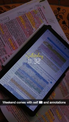 a tablet computer sitting on top of a table next to an open book with the words weekend comes with self and annotations