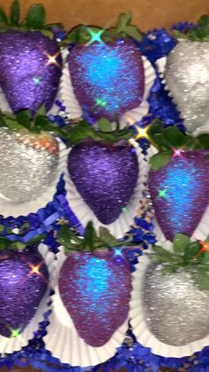 purple and silver strawberries with green leaves on them