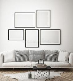 modern living room with white couches and black and white pictures on the wall above