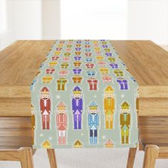 an image of a table with a cloth on it that has people in different colors