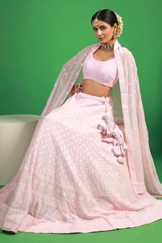 Pink lehenga with attached can can and thread embroidered floral jaal motifs. Comes with padded blouse and dupatta.
Components: 3
Pattern: Embroidered
Type Of Work: Thread, Sequin
Neckline: Round
Sleeve Type: Sleeveless
Fabric: Georgette
Color: Pink
Other Details: 
Attached lining
Lehenga Length: 42 inches
Model Height: 5ft 4inches wearing size S
Closure: 
Lehenga: Side drawstring
Blouse: Back hook
Occasion: Mehendi and Haldi,Sangeet - Aza Fashions Semi-stitched Lehenga With Chikankari Embroidery For Designer Wear, Semi-stitched Chikankari Embroidery Sets For Reception, Fitted Bollywood Lehenga With Chikankari Embroidery, Festive Choli With Chikankari Embroidery For Reception, Chikankari Embroidery Choli For Reception During Eid, Fitted Anarkali Choli With Chikankari Embroidery, Bollywood Lehenga With Chikankari For Reception, Fitted Pink Embroidered Fabric With Cutdana, Fitted Lehenga With Chikankari Embroidery For Wedding