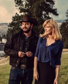 a man standing next to a woman in a field