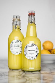 two bottles of lemonade sitting on top of a counter