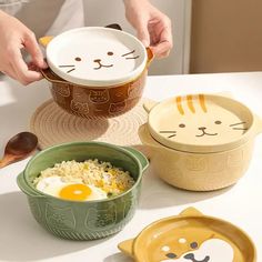 Add a touch of whimsy and charm to your dining experience with these Cartoon Ceramic Cat Dog Noodle Bowls With Lids. Crafted from high-quality ceramic material, these bowls are not only adorable but also durable for everyday use. Perfect for serving soups, salads, fruits, or noodles, these bowls feature a cute animal design that will bring a smile to your face every time you use them. Each bowl is hand-painted with a solid pattern, making them unique and one-of-a-kind. With a capacity of less than 1 liter, these bowls are perfect for individual servings. The Axya Ceramic Cat Dog Noodle Bowls are CE/EU, CIQ, EEC, LFGB, and SGS certified, ensuring that they meet the highest standards of quality and safety. Whether you're enjoying a cozy night in or hosting a dinner party, these bowls will ma Led Logo, Salad Fruit, Cat Food Bowl, Tanah Liat, Keramik Design, Ceramic Cat, Cute Kitchen, Noodle Bowls, Food Bowl