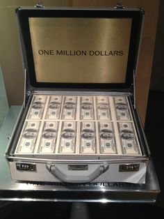 a briefcase filled with money sitting on top of a table