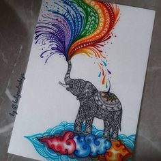 an elephant with colorful feathers on it's head is standing on top of a cloud