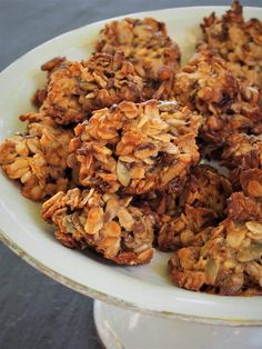 a white plate topped with cookies covered in granola