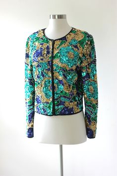 "So pretty.. All the floral on this jacket is outlined in gold beads...sooo beautiful..There is green floral, gold beads and sequins and navy in the background...just so pretty!! Excellent condition! Measuring: 19\" long Width: 36\" Sleeves: 22\" Pet Free/smoke free Excellent!! Enjoy!" Spring Embellished Gold Outerwear, Embellished Gold Outerwear For Spring, Gold Embellished Outerwear For Spring, Sequin Jacket, Womens Jackets, Jacket Vintage, Cropped Jacket, Crop Jacket, Gold Beads