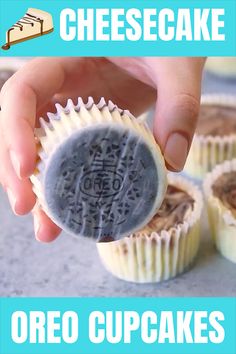 someone is holding an oreo cupcake in front of some cheesecakes on the table