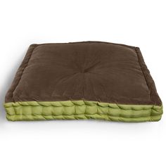 a brown and green dog bed sitting on top of a white floor