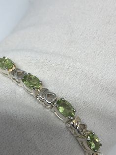 This Peridot bracelet is very lively and bright. The stones are deep colors and well matched. The sterling silver is plated with rhodium to protect the bracelet from tarnish and give the appearance of white gold. 7.5 inches My jeweler can shorten it All jewelry is shipped in a nice gift box. Check out our over a THOUSAND great reviews Engraving is $4 per letter and is not always perfect depending on the piece. It can take a few days if the jeweler is busy. This is payable to Paypal Judithsltd@gm Peridot Bracelet, Green Peridot, Deep Colors, Tennis Bracelet, Chain Link Bracelet, Arm Band, Silver Bracelet, Best Gifts, Bracelet