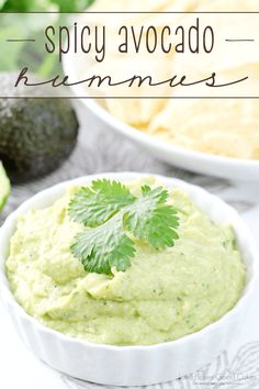 a bowl of guacamole and chips with the words spicy avocado hummus above it