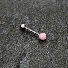 a single pink ball and barbell ring on the ground