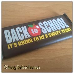 back to school candy bar sitting on top of a wooden table with the words, it's going to be a sweet year