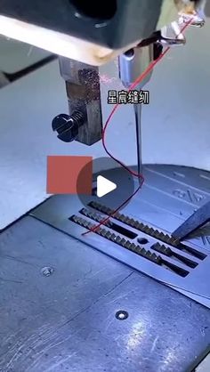 a machine that is cutting something on the table with scissors and wires attached to it