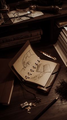 an open book sitting on top of a wooden table next to a pen and eyeglasses