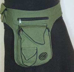 a woman's green purse is shown in the shape of a waist bag with an arrow on it