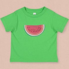 🍉This minimal watermelon graphic toddler tee with its subtle retro feel comes straight from the pages of yesteryear. This wedge of watermelon graphic tee is supper sweet without being sticky, no guarantees for a sticky free toddler 😊. Its a perfect companion for your a pair of jean shorts and a hot summer day ☀️. This 4.5 oz. 100% combed ring spun cotton fine jersey toddler tee is super soft, and durable. With topstitched ribbed collar, Shoulder-to-shoulder self-fabric back neck tape, double n Playful Red T-shirt For Summer, Playful Green Summer Tops, Playful Green Tops For Summer, Playful Red Summer T-shirt, Playful Green Tops With Funny Print, Playful Green Spring T-shirt, Playful Summer Tops With Fruit Print, Pink Fruit Print T-shirt For Summer, Summer Watermelon Cotton Tops