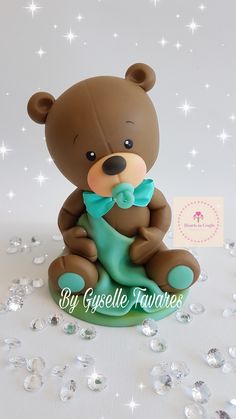 a brown bear figurine sitting on top of a table next to some diamonds