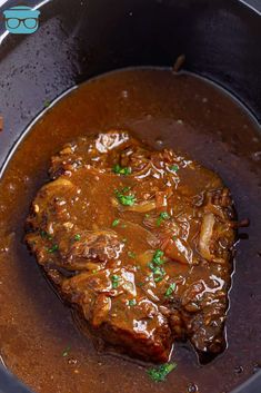 the meat is covered in gravy and garnished with parsley