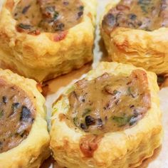 several small pastries are arranged on a piece of parchment paper