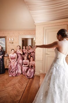 a bride and her bridal party in the background