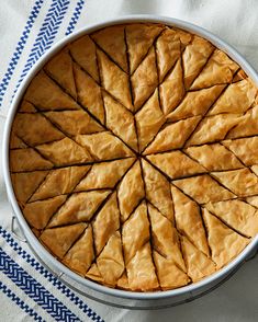 a pie sitting on top of a blue and white table cloth