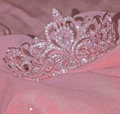 a tiara sitting on top of a pink cloth