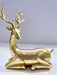 a golden deer figurine sitting on top of a table