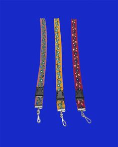 three lanyards with different colors and designs on them