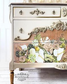 an old dresser with flowers painted on it