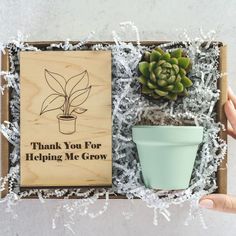 someone is holding a box with a plant in it that says thank you for helping me grow