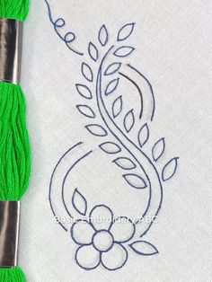 the thread is being used to make this embroidery design on a piece of white fabric