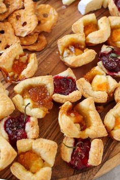 small pastries are arranged on a wooden platter