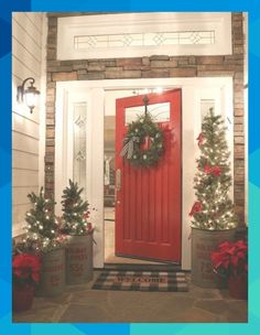 a red front door decorated with christmas wreaths and poinsettia's