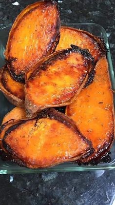 grilled sweet potatoes in a glass dish on a granite countertop, ready to be eaten