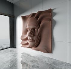 a wall sculpture in the corner of a room with a large window looking out onto an ocean