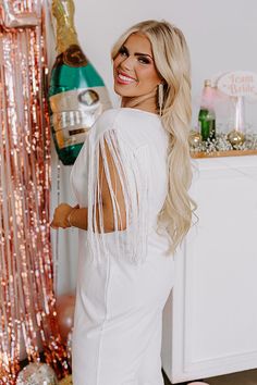 - This stunning jumpsuit is a total showstopper! - Stretchy material - A lined bodice - A deep-v cut neckline - A sleeveless cut with wide straps - Fringe feature at the shoulders - Back zip closure - A relaxed silhouette that ends in straight floor length hemlines White Jumpsuits And Rompers For Party Season, White Jumpsuits And Rompers For Party, Summer Party Cream Jumpsuits And Rompers, Spring Cream Party Jumpsuits And Rompers, Cream Jumpsuits And Rompers For Spring Party, Fitted Cream Jumpsuits And Rompers For Party, V Cuts, Wide Straps, Stretchy Material