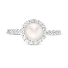 Make a wonderful impression with this beautiful pearl ring. Crafted in sterling silver, this breathtaking design features a lustrous 7.0mm freshwater cultured pearl wrapped in a frame of sparkling petite lab-created white sapphires. Additional created sapphires line the shank. Polished to a bright shine, this ring fits perfectly into her wardrobe. Custom-made to fit her ring size. Sterling silver rings cannot be resized after purchase. Classic Halo Pearl Ring, Halo Pearl Ring For Anniversary, Classic Round Pearl Ring With Halo Design, Classic Pearl Ring With Halo Design, Pearl Ring With Halo Setting, Halo Setting Round Cut Pearl Ring, Pearl Ring With Halo Design For Anniversary, Brilliant Cut Pearl Ring, Round Pearl Ring With Halo Design For Anniversary