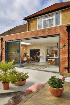 an open patio with potted plants on the ground