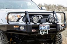 the front end of a white toyota truck