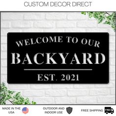 a black welcome sign with the words welcome to our backyard est 2091 on it