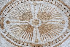 an intricately designed wall hanging made out of jute and rope with circles in the center