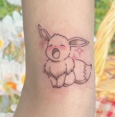 a small tattoo on the leg of a person with a koala in it's lap