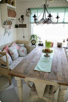 a wooden table sitting in front of a window