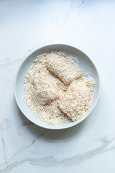 a white bowl filled with food on top of a table