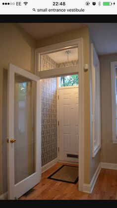 an open door leading to another room in a house with hardwood floors and walls,