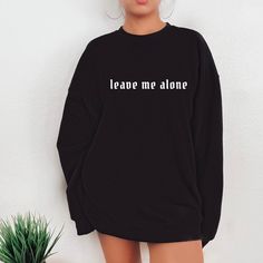 "Leave me alone Shirt, Anti Social Shirt, Goth Clothing, Grunge Sweatshirt, Gift For Her, Emo Shirt, Introvert Shirt Oversized sweatshirt Gifts Fall in love with this soft and cozy Unisex Graphic Tee or sweatshirt Please read TO MAKE YOUR SHOPPING EXPERIENCE EASIER, YOU CAN \"CHOOSE\" A T SHIRT, SWEATSHIRT OR HOODIE IN THIS LISTING. Available in Shirt, Sweatshirt and Hoodie Tee Shirt Shirt Sleeve Crewneck 100% Cotton Unisex Fit Sweatshirt and Hoodies Long Sleeve Soft 50/50 blend S-5X Unisex Fit Oversized Band Merch Long Sleeve Sweatshirt, Oversized Band Merch Sweatshirt With Letter Print, Black Band Merch Sweatshirt With Slogan, Oversized Long Sleeve Band Merch Sweatshirt, Band Merch Long Sleeve Sweatshirt With Slogan, Grunge Long Sleeve Tops With Slogan, Oversized Long Sleeve Tops With Slogan, Grunge Long Sleeve Sweater With Letter Print, Oversized Long Sleeve Slogan Sweatshirt