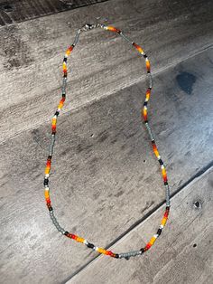 Grey seed bead and sunset colored pattern claw clasp 16 inch necklace Orange Beaded Necklaces With Lobster Clasp, Orange Round Beaded Necklace With Lobster Clasp, Orange Necklaces With Round Beads And Lobster Clasp, Orange Necklace With Round Beads And Lobster Clasp, Orange Hand-strung Beaded Necklaces For Festivals, Festival Orange Hand-strung Beaded Necklaces, 16 Inch Necklace, Cedar Rapids, Sunset Colors