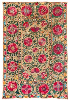 an antique rug with many circular designs and flowers on the side, in red and green colors